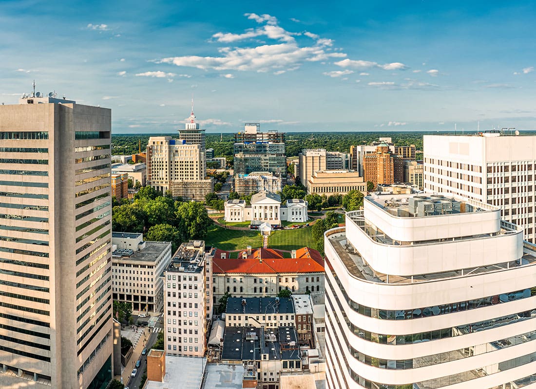 Contact - View of Modern Commercial Buildings in Downtown Richmond Virginia Against a Bright Blue Sky