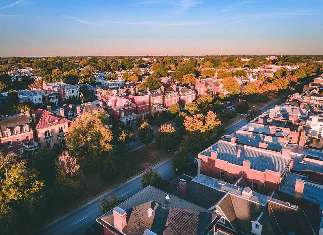 Insurance Solutions - Aerial View of a Small Neighborhood with Older Homes and Apartments Surrounded by Green Foliage in Richmond Virginia at Sunset