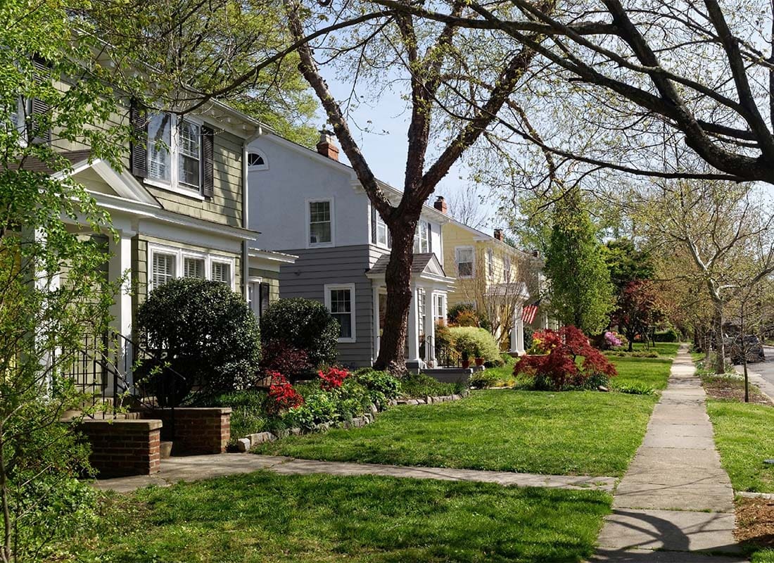 Midlothian, VA - Row of Homes with Green Grass and Flowers in the Suburbs of Midlothian Virginia on a Sunny Day